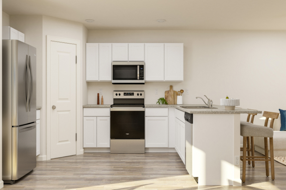 A kitchen with white cabinets.