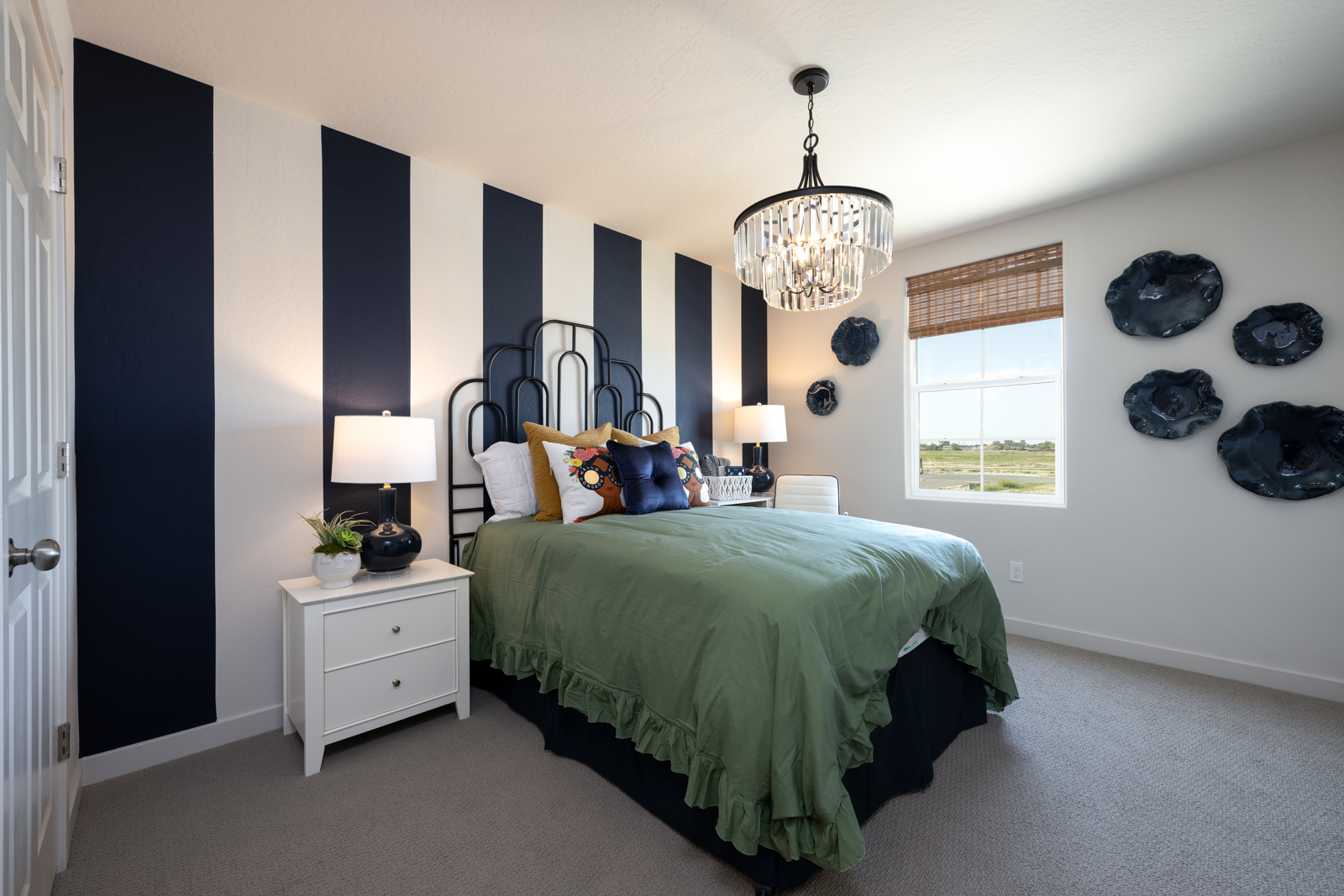 A bedroom with a bed and lamps.