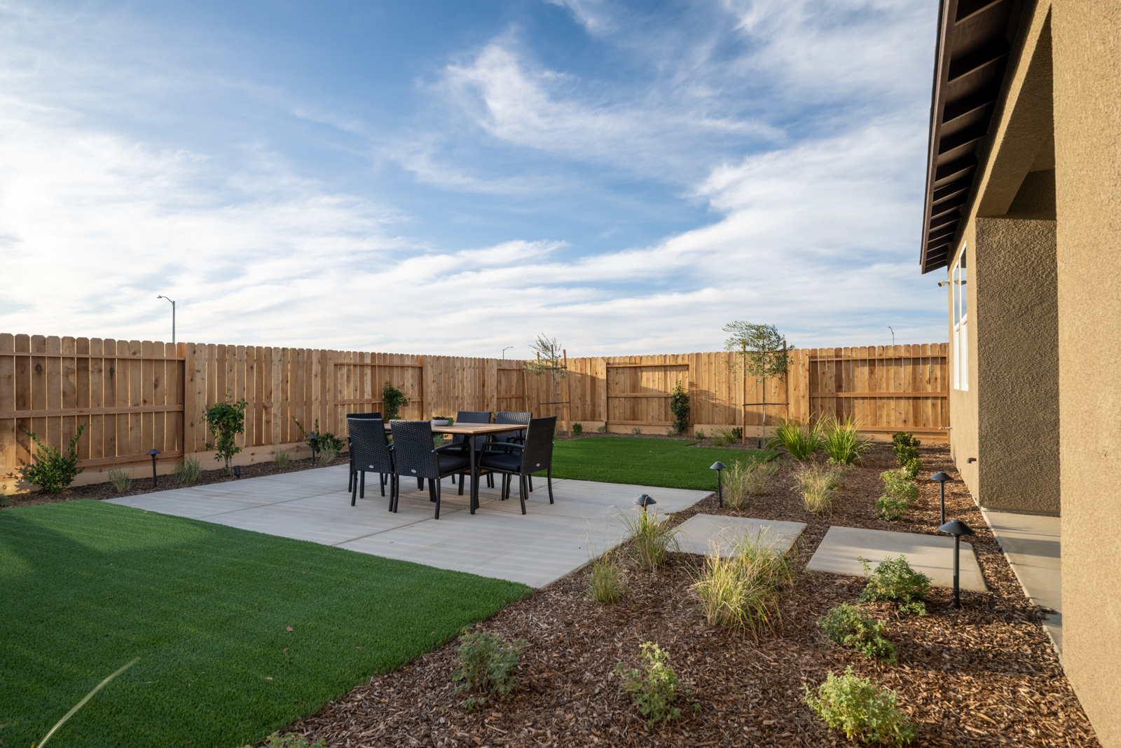 A backyard with a table and chairs.