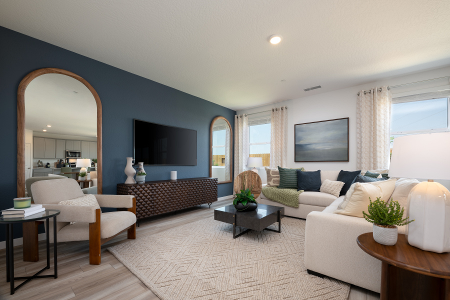 A living room with a large mirror.