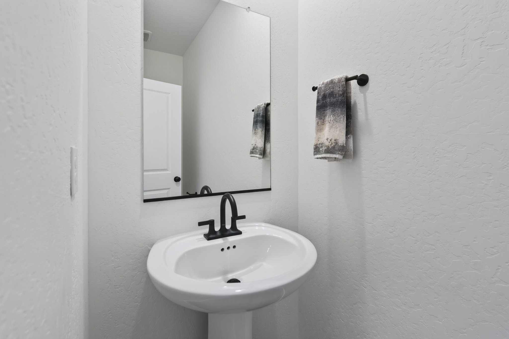 A bathroom with a mirror and sink.
