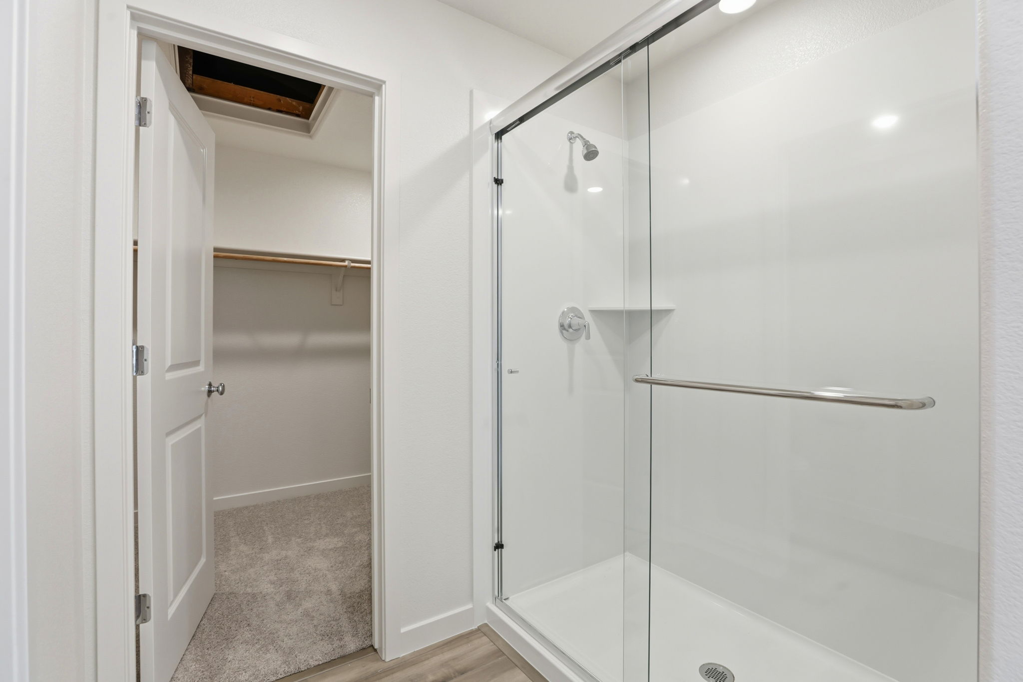 A bathroom with a shower unit and a bathtub.