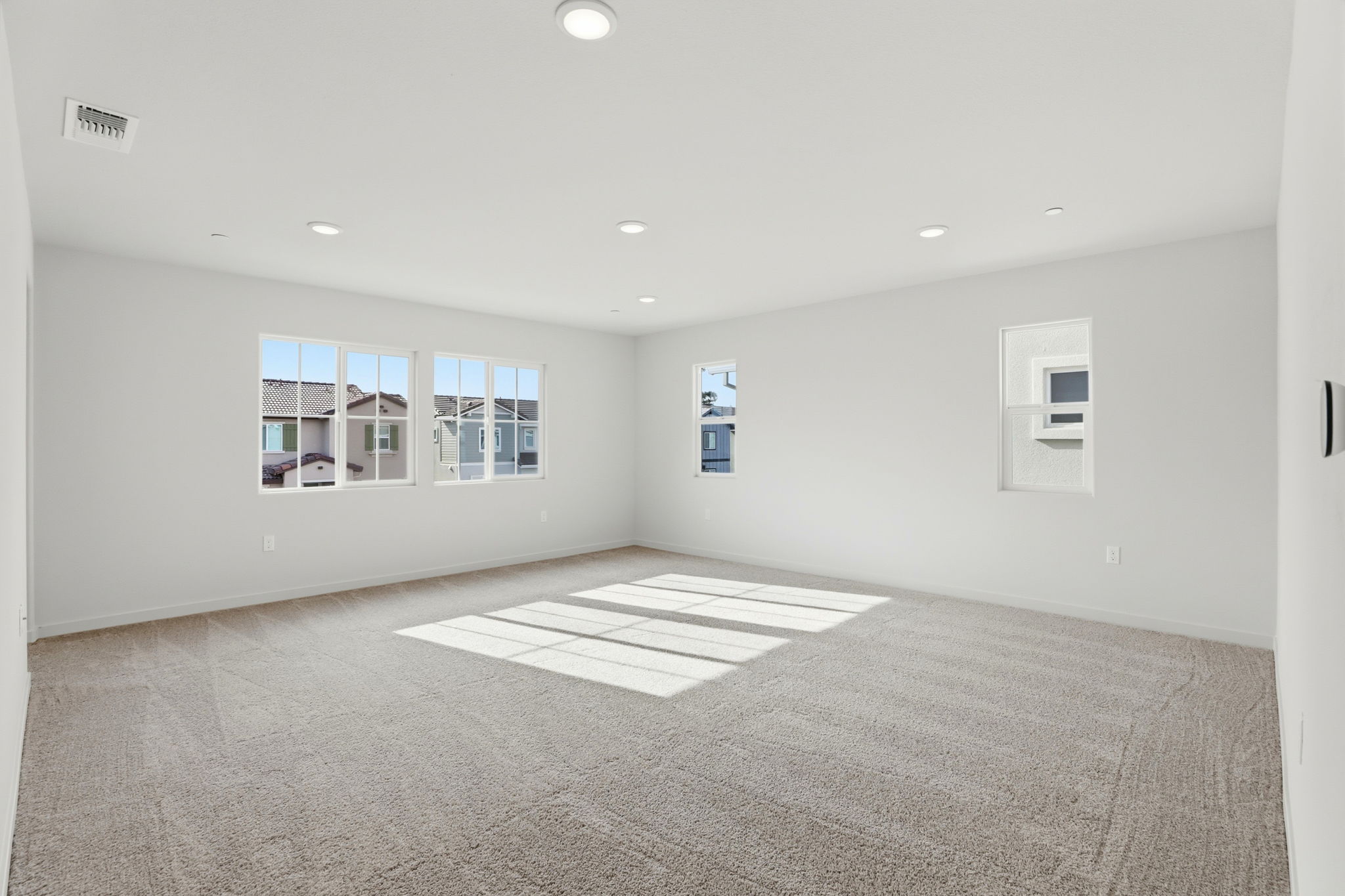 A room with a rug and windows.