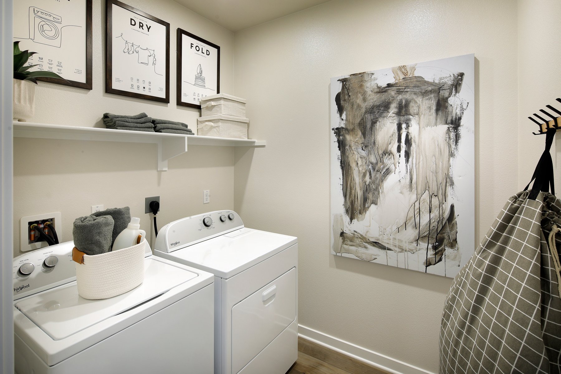 A room with a shelf and a sink with a picture on it.