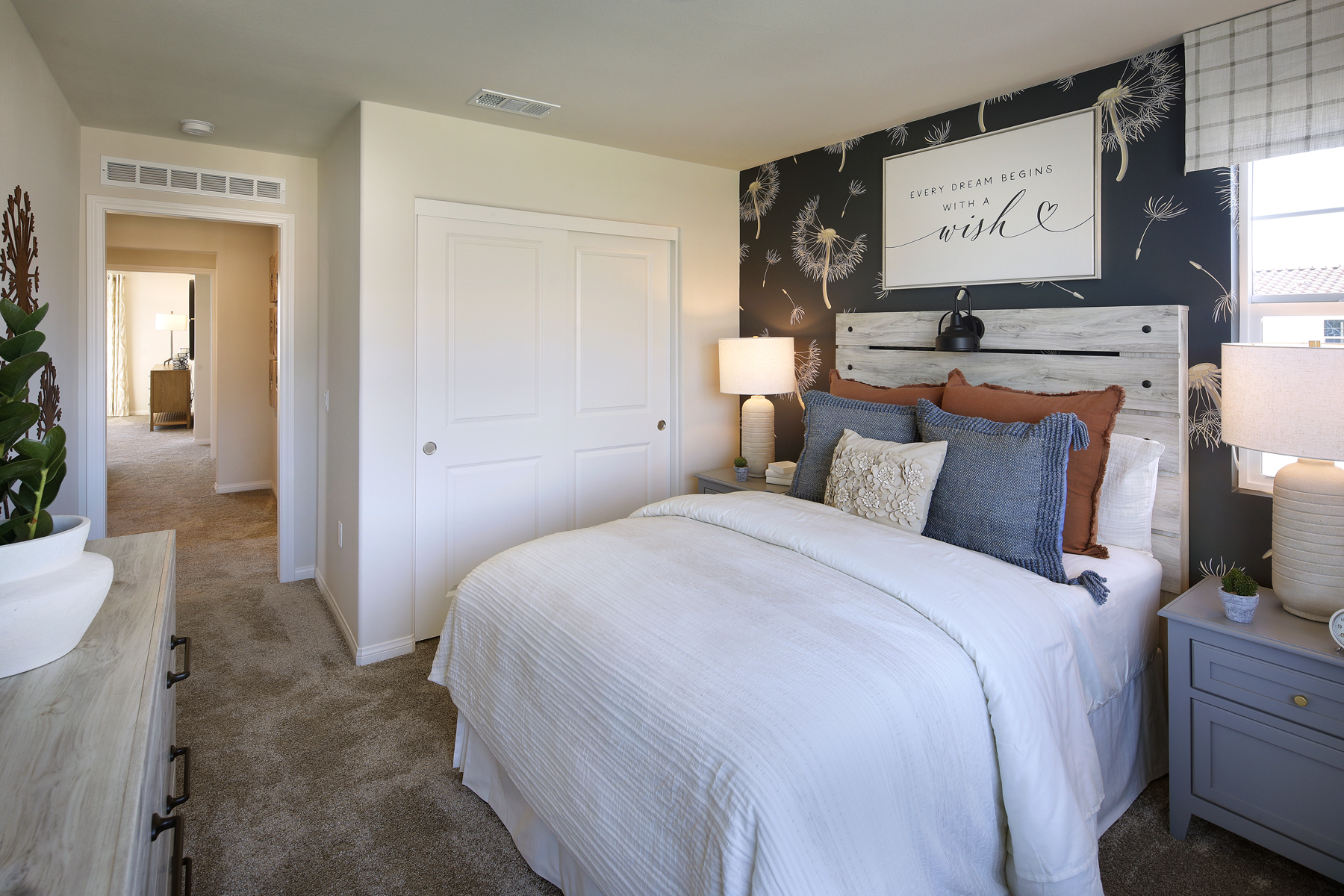 A bedroom with a bed and a dresser.
