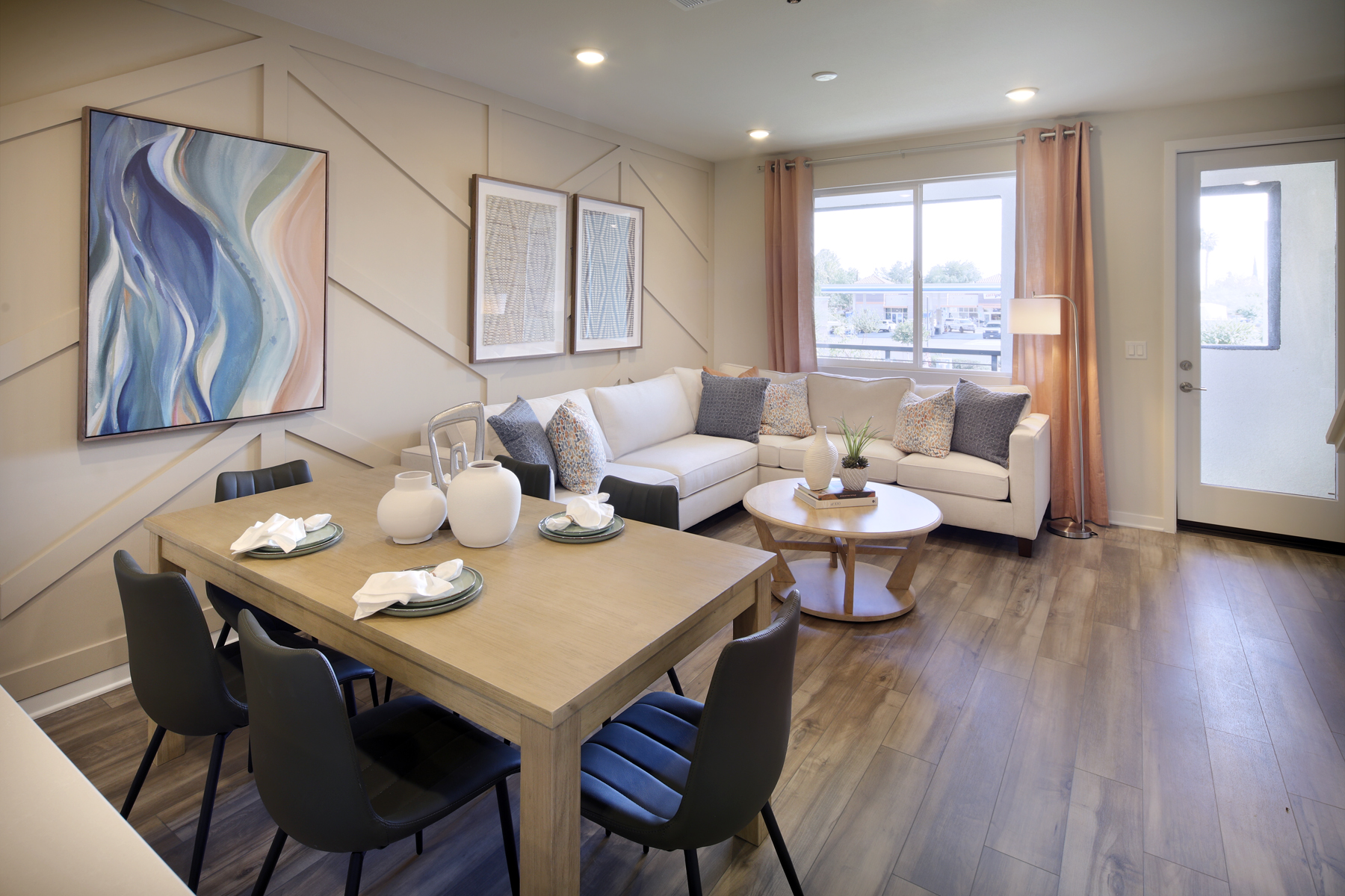 A living room with a large table and chairs.