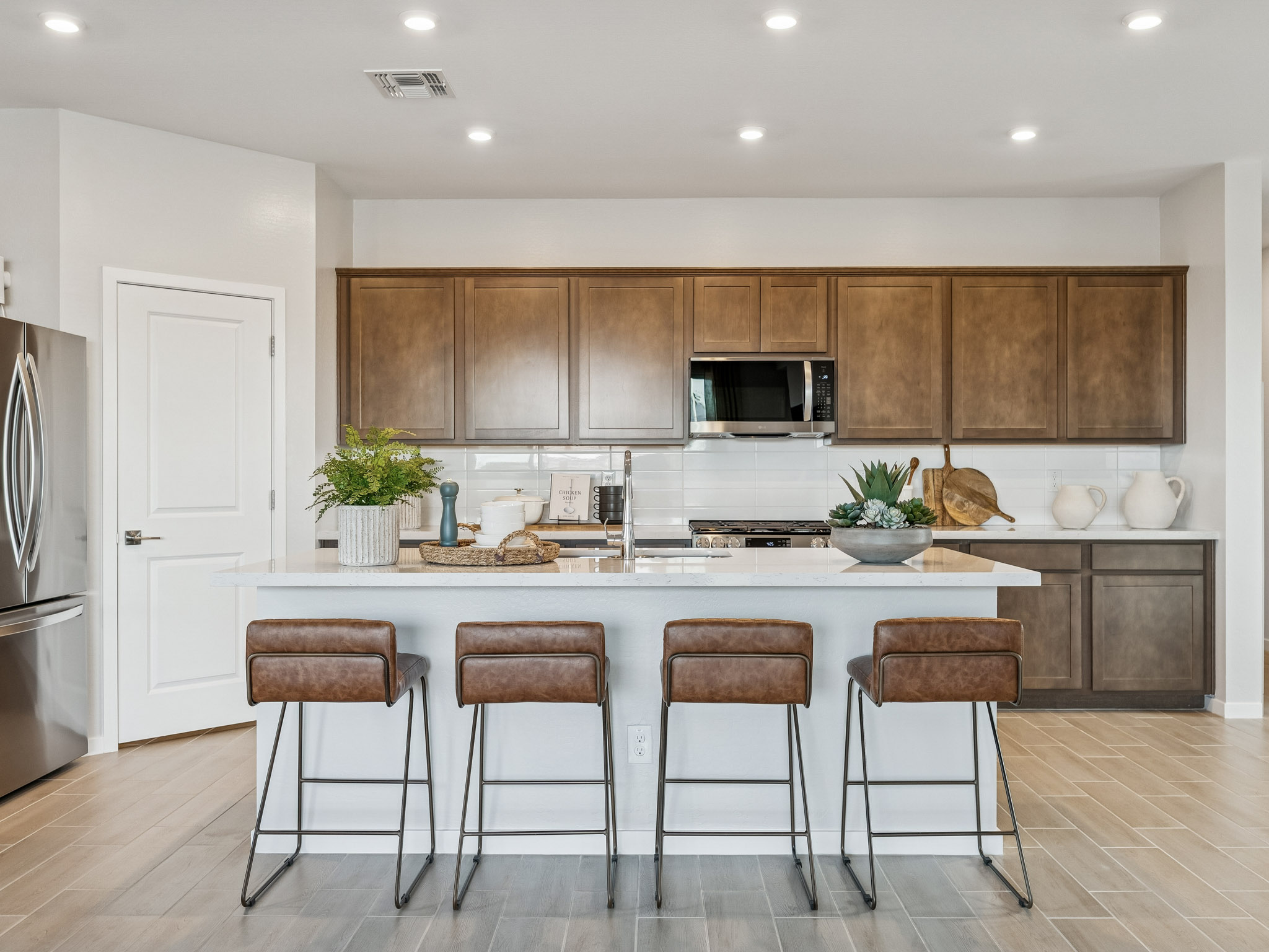 A kitchen with a marble island.