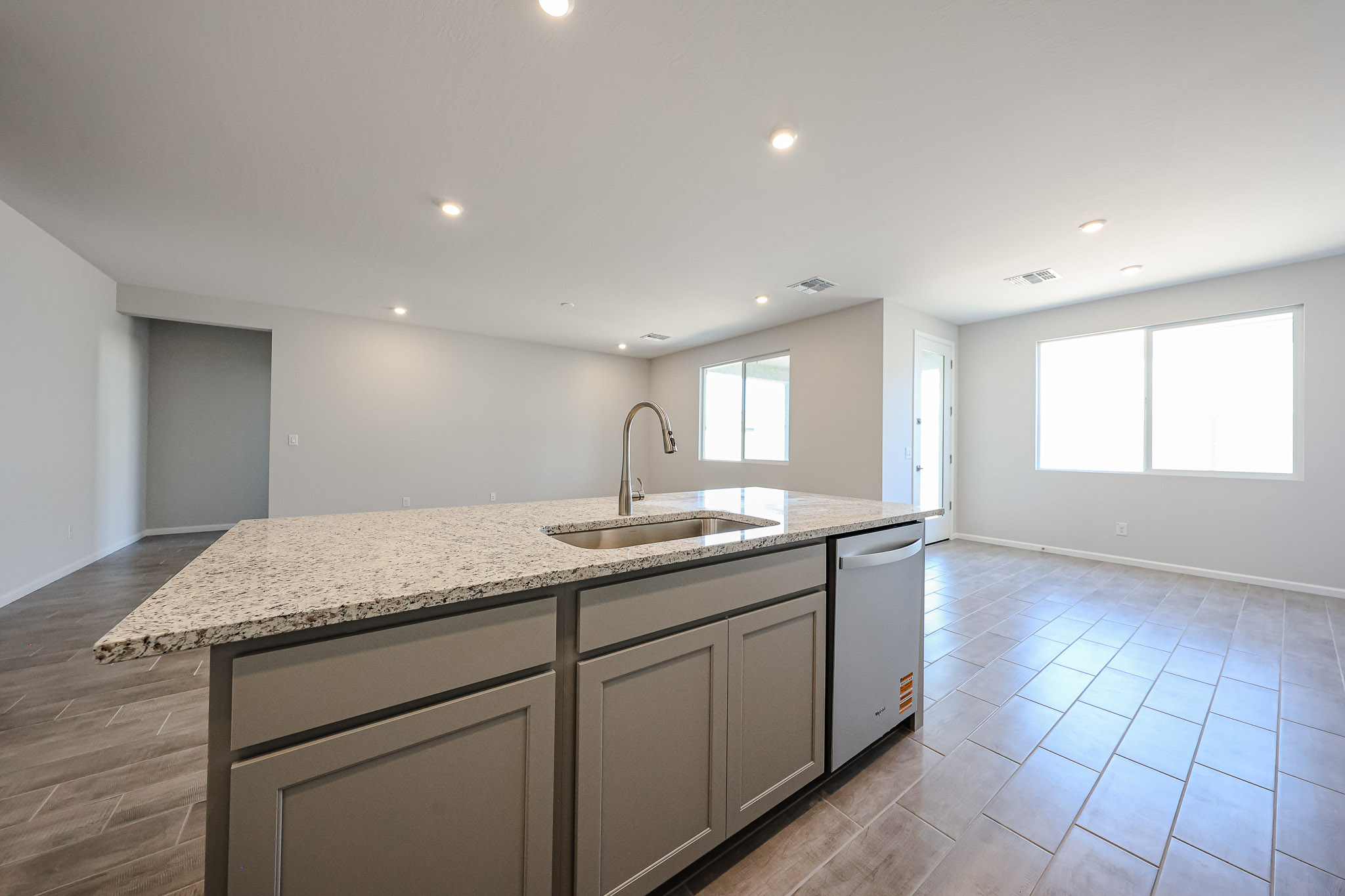 A kitchen with marble counters.