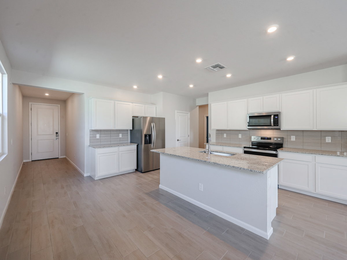 A large kitchen with white cabinets.