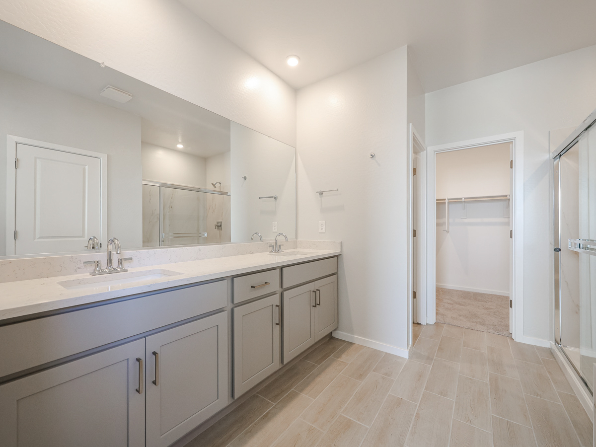 A bathroom with white cabinets.