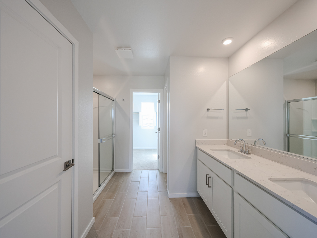 A bathroom with white cabinets.