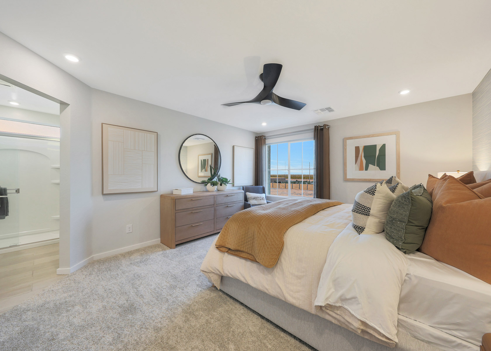 A bedroom with a bed and a fan.