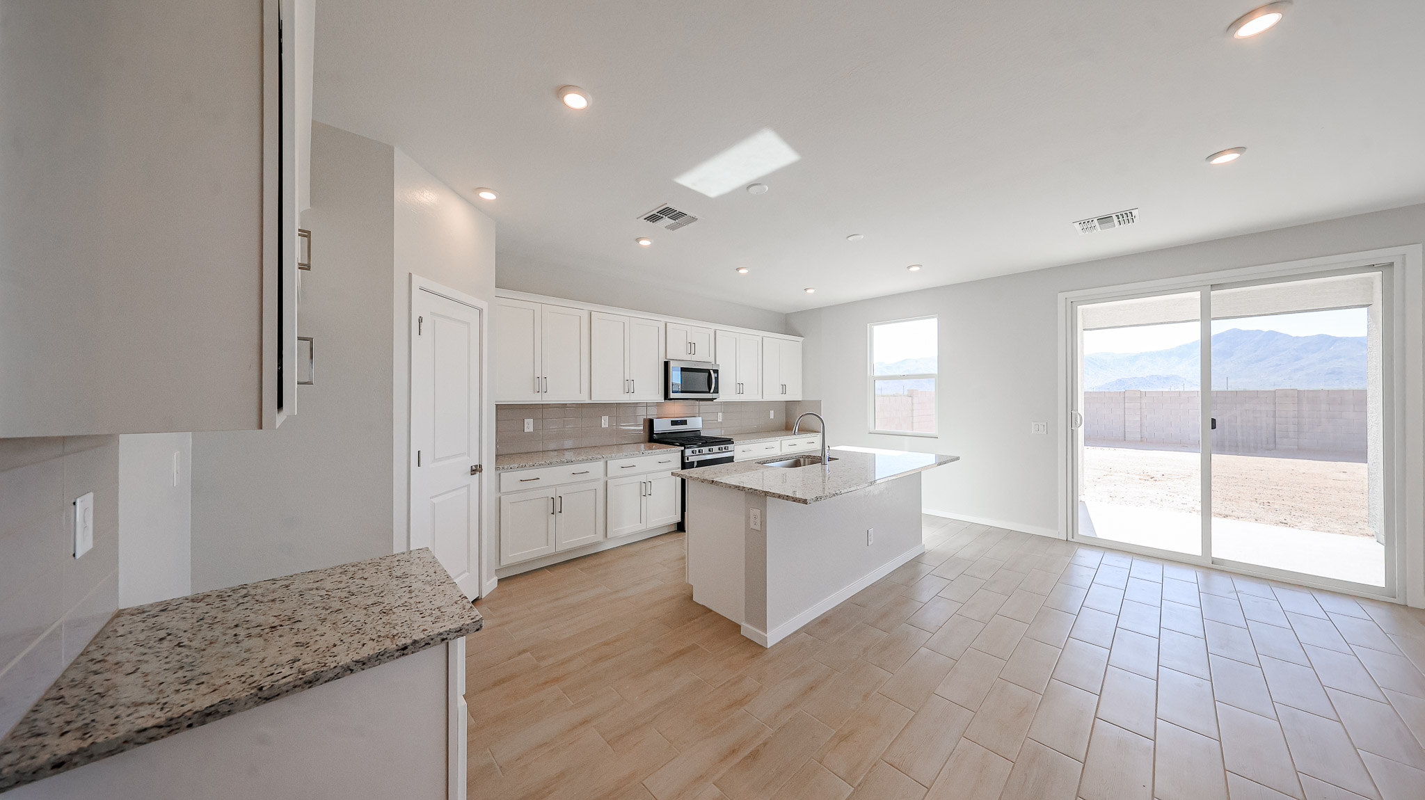 A kitchen with white cabinets.