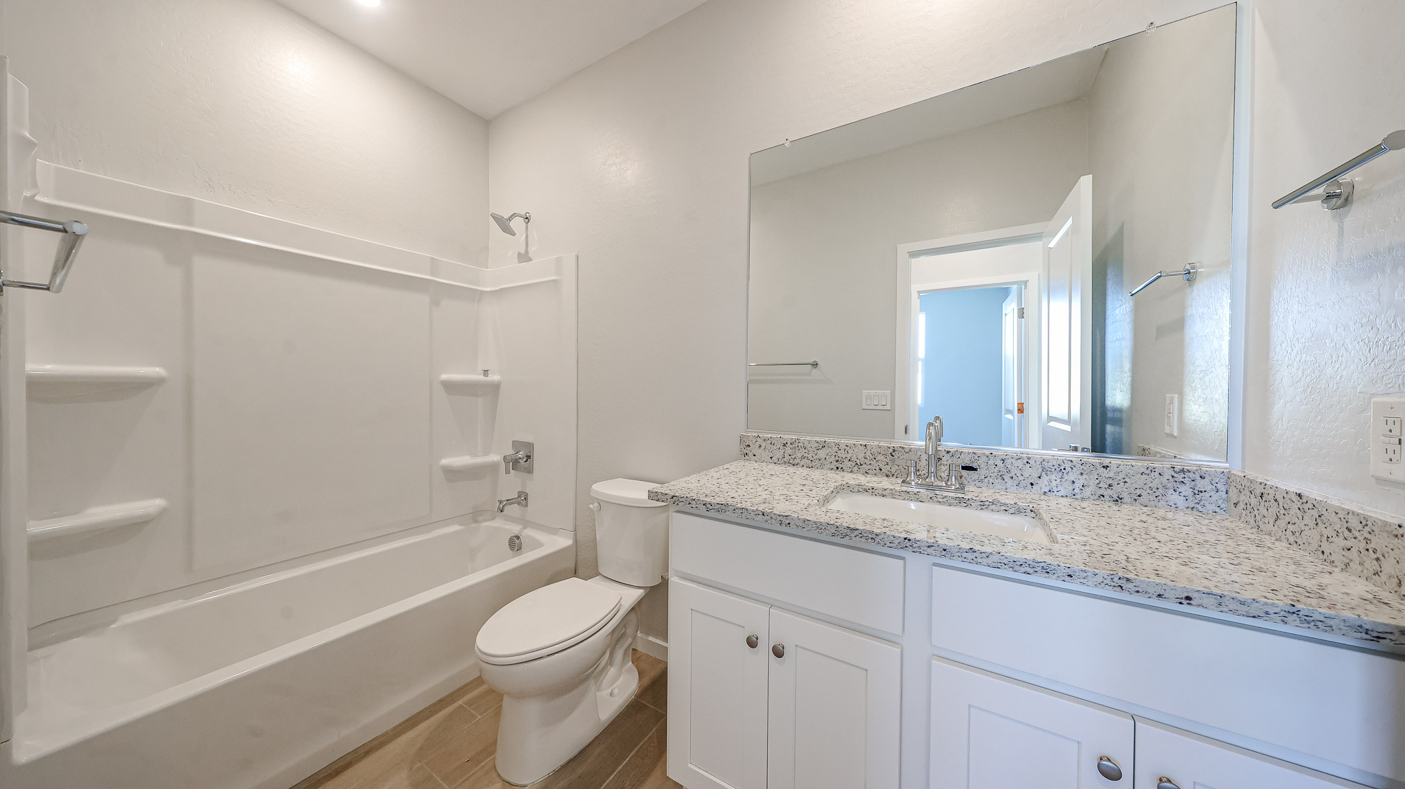 A bathroom with a tub sink and toilet.