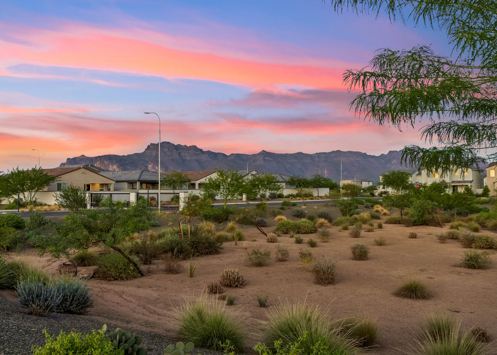 A desert landscape with a building and mountains in the background.
