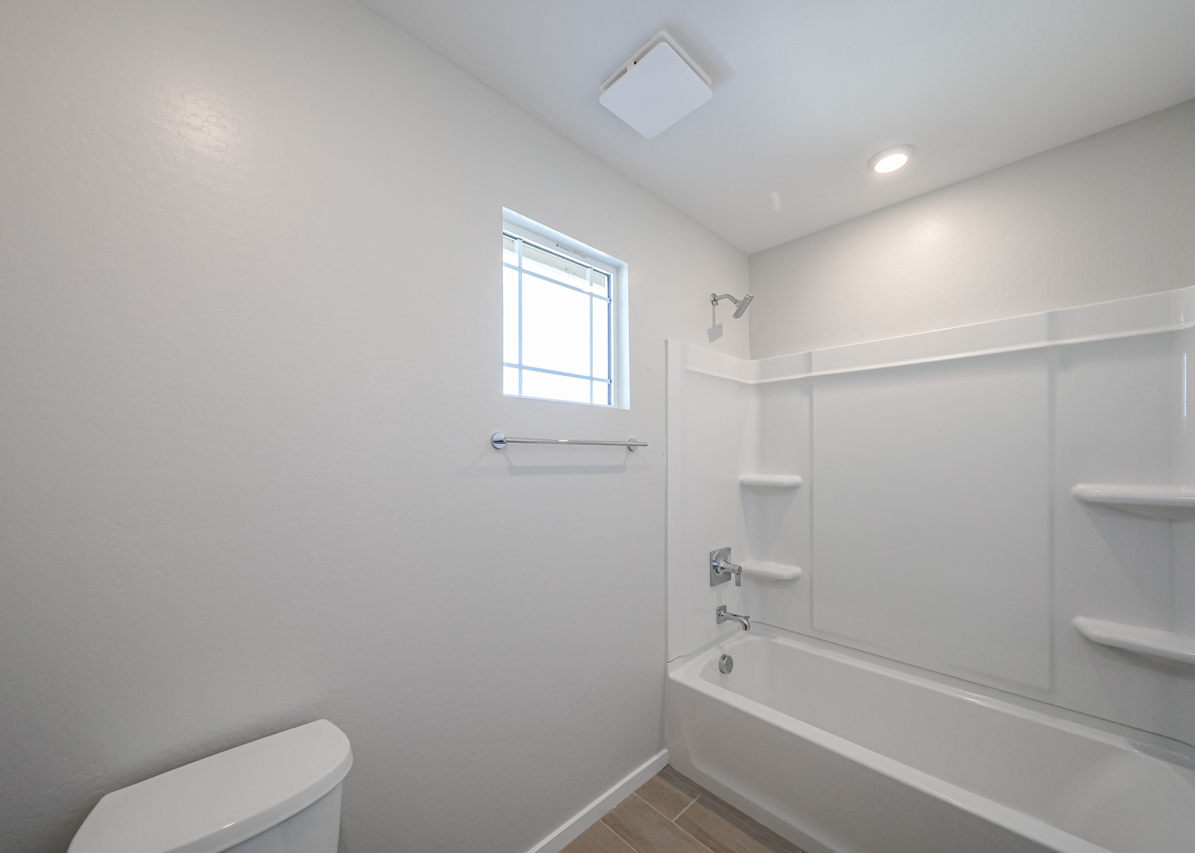 A bathroom with a tub toilet and sink.