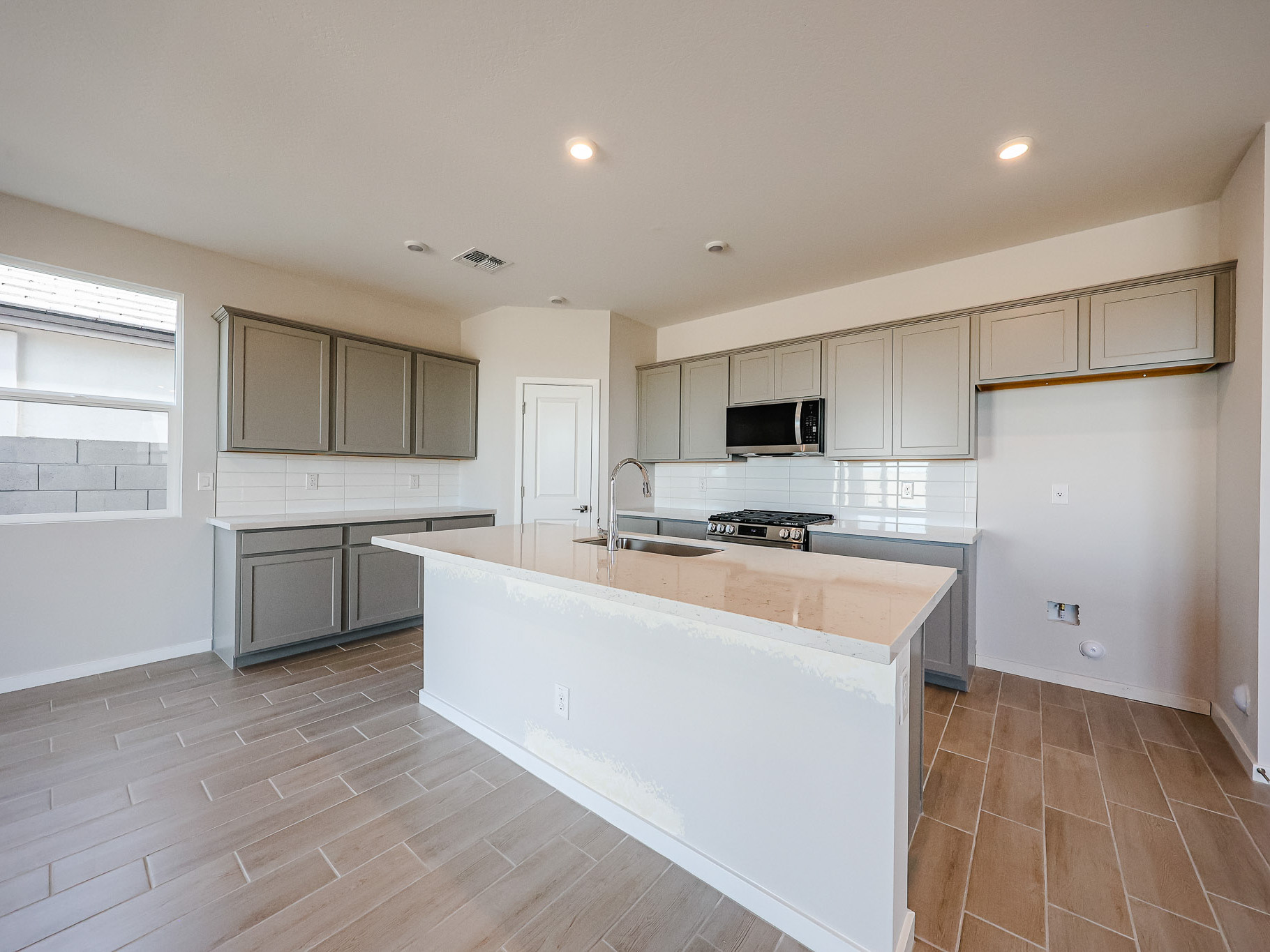 A kitchen with white cabinets.
