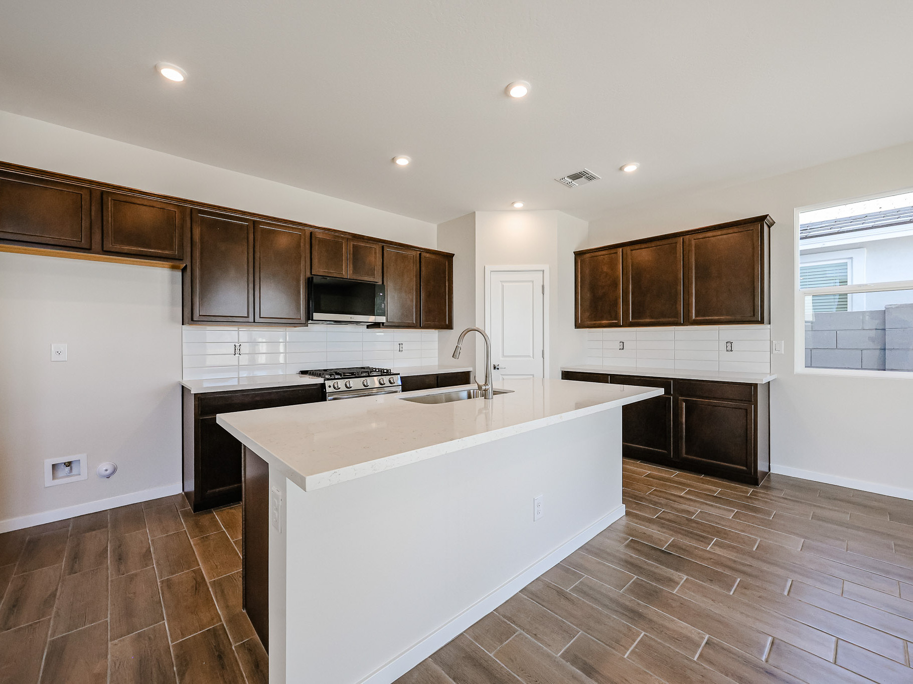 A kitchen with wooden cabinets.