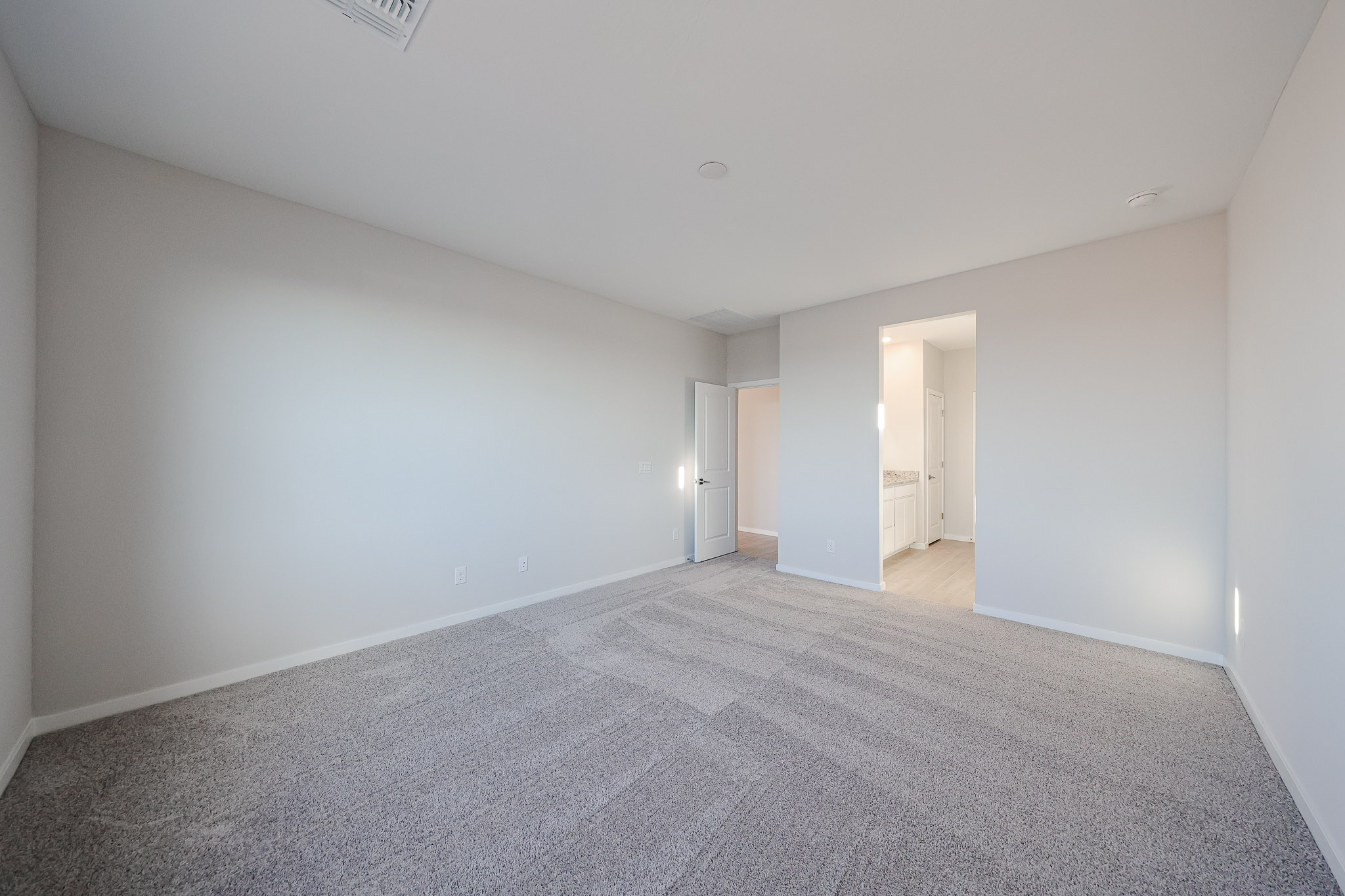 A long hallway with doors.