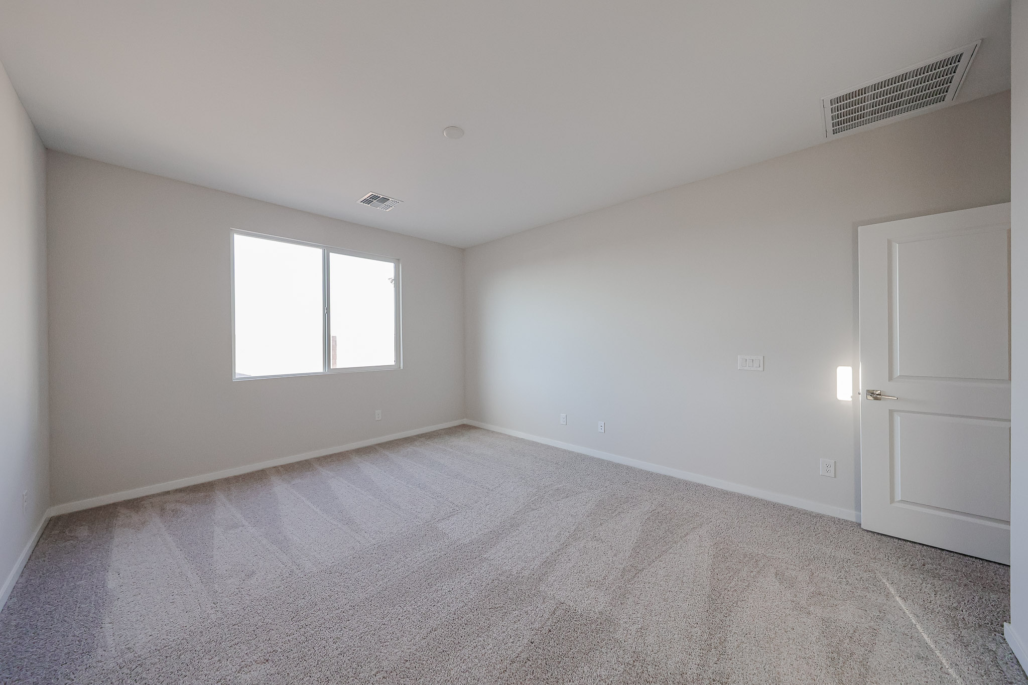 A room with a door and a window.