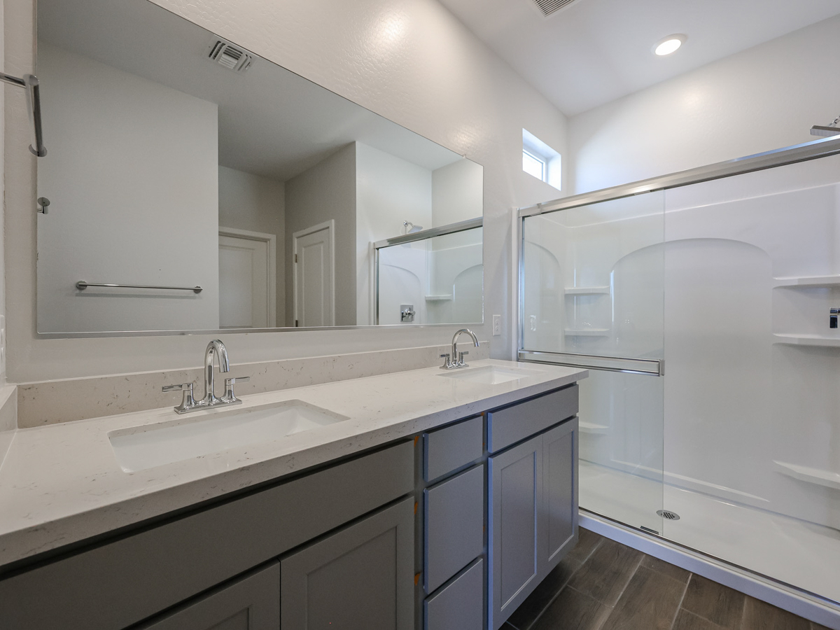 A bathroom with a large mirror.
