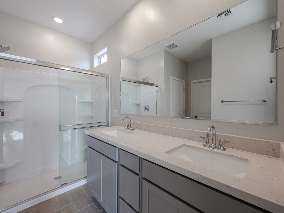 A bathroom with a large mirror.