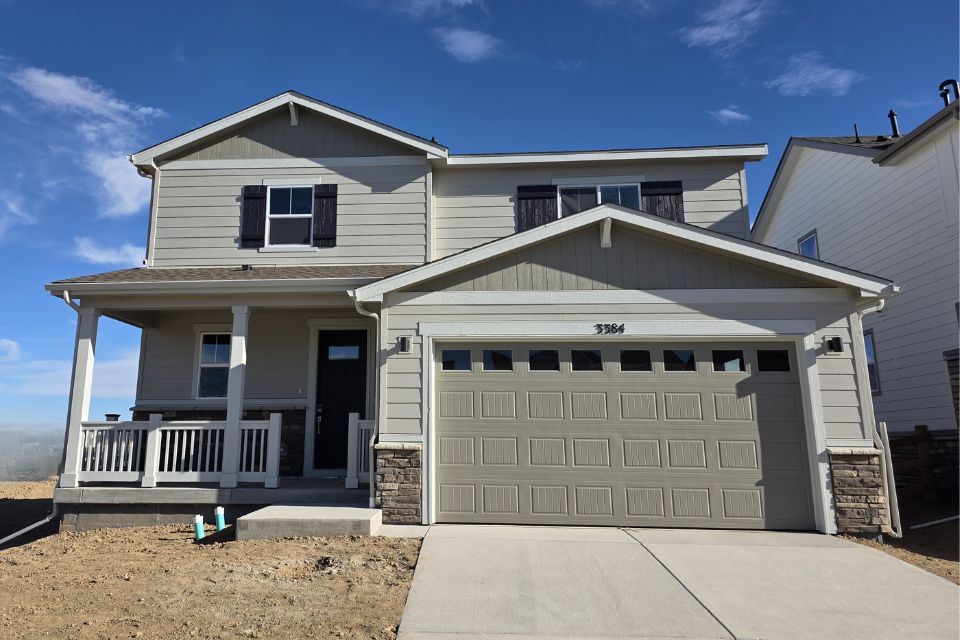A white house with a garage.