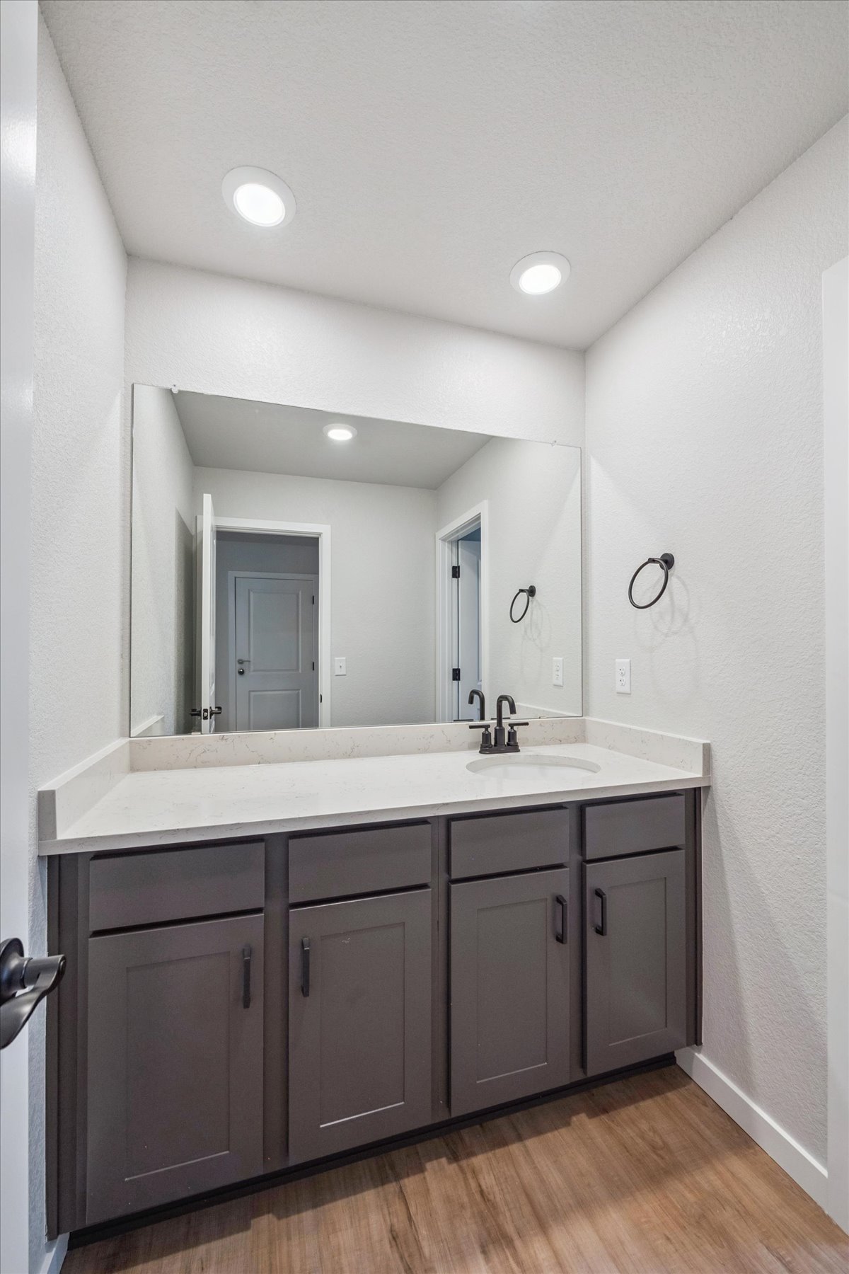 A bathroom with a large mirror.