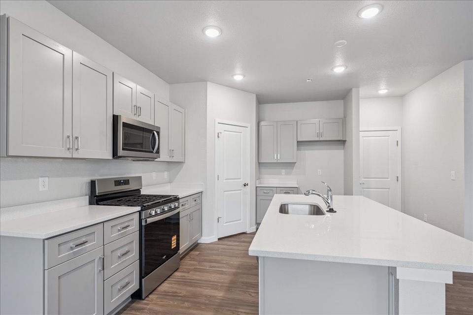 A kitchen with white cabinets.