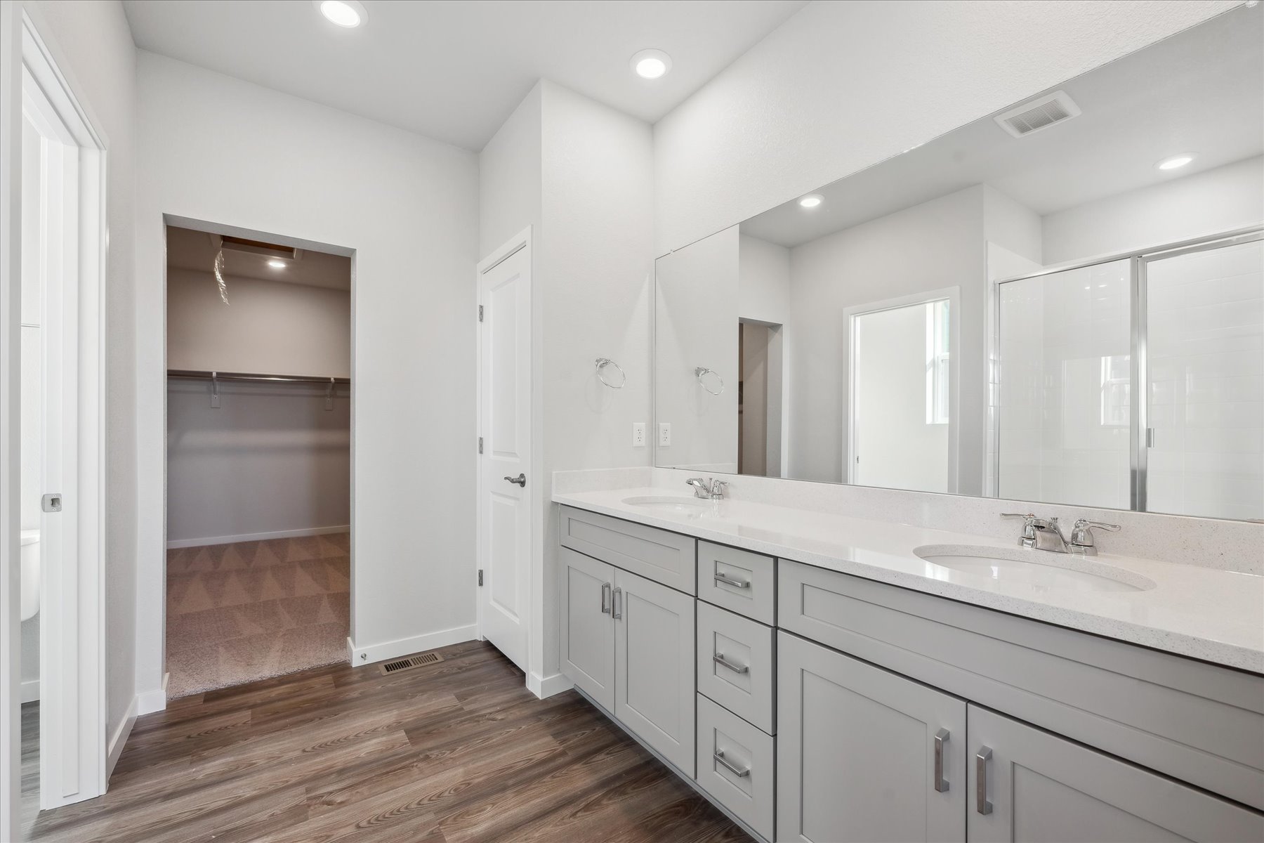 A bathroom with white cabinets.