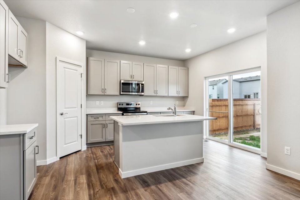 A kitchen with white cabinets.