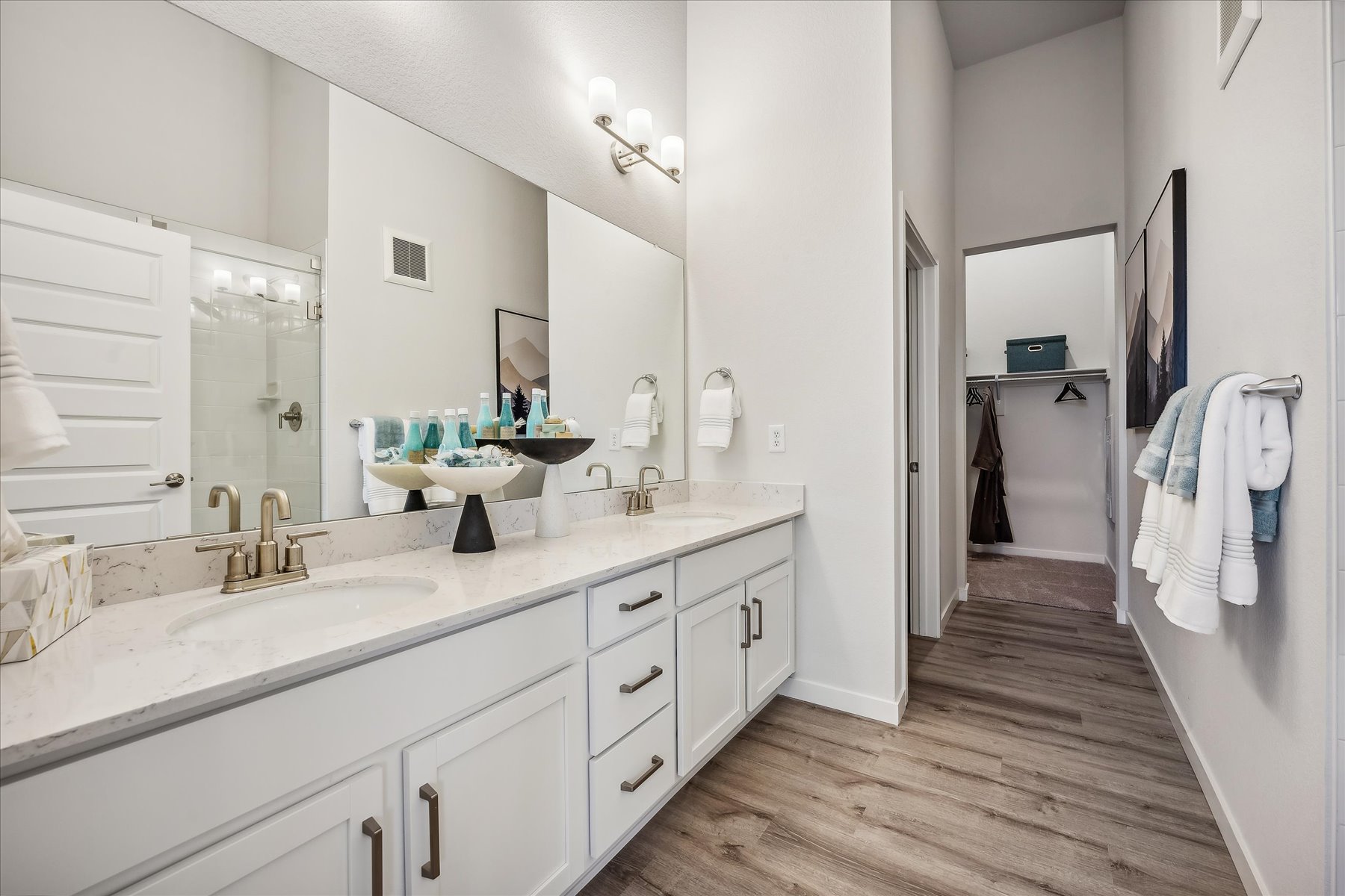 A bathroom with a large mirror.