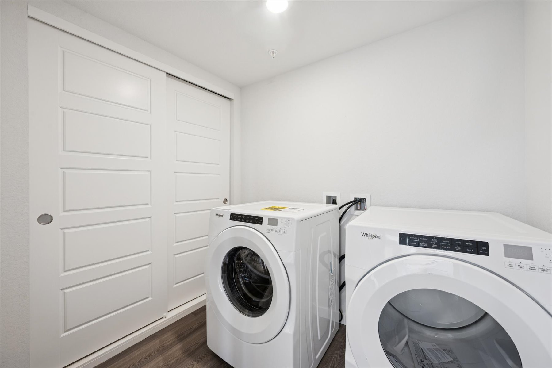 A washing machine and dryer in a room.