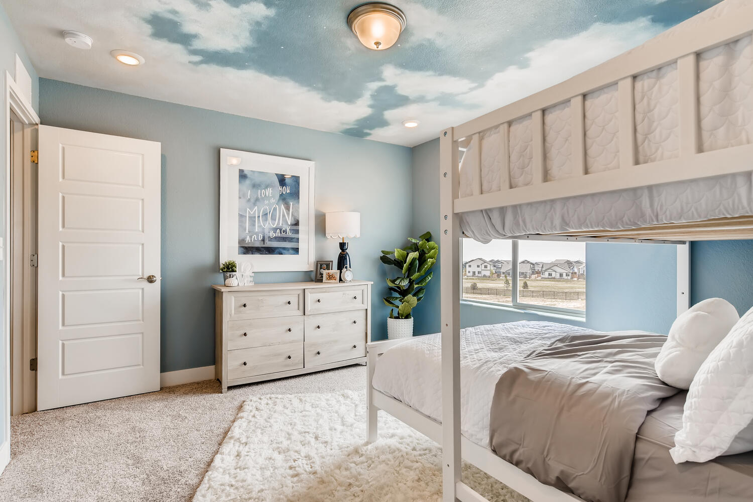 A bedroom with a bed and a window.