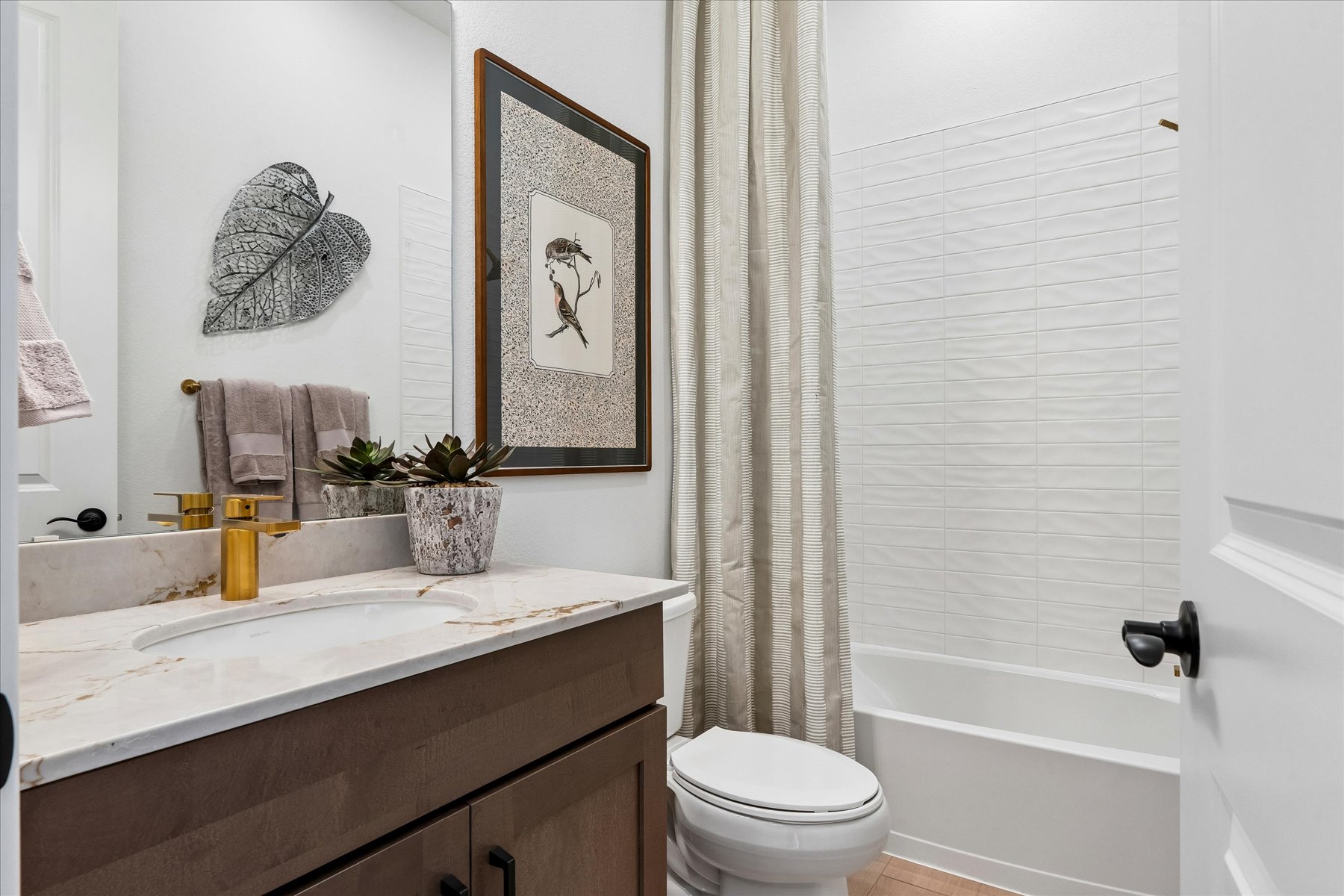 A bathroom with a white shower curtain.