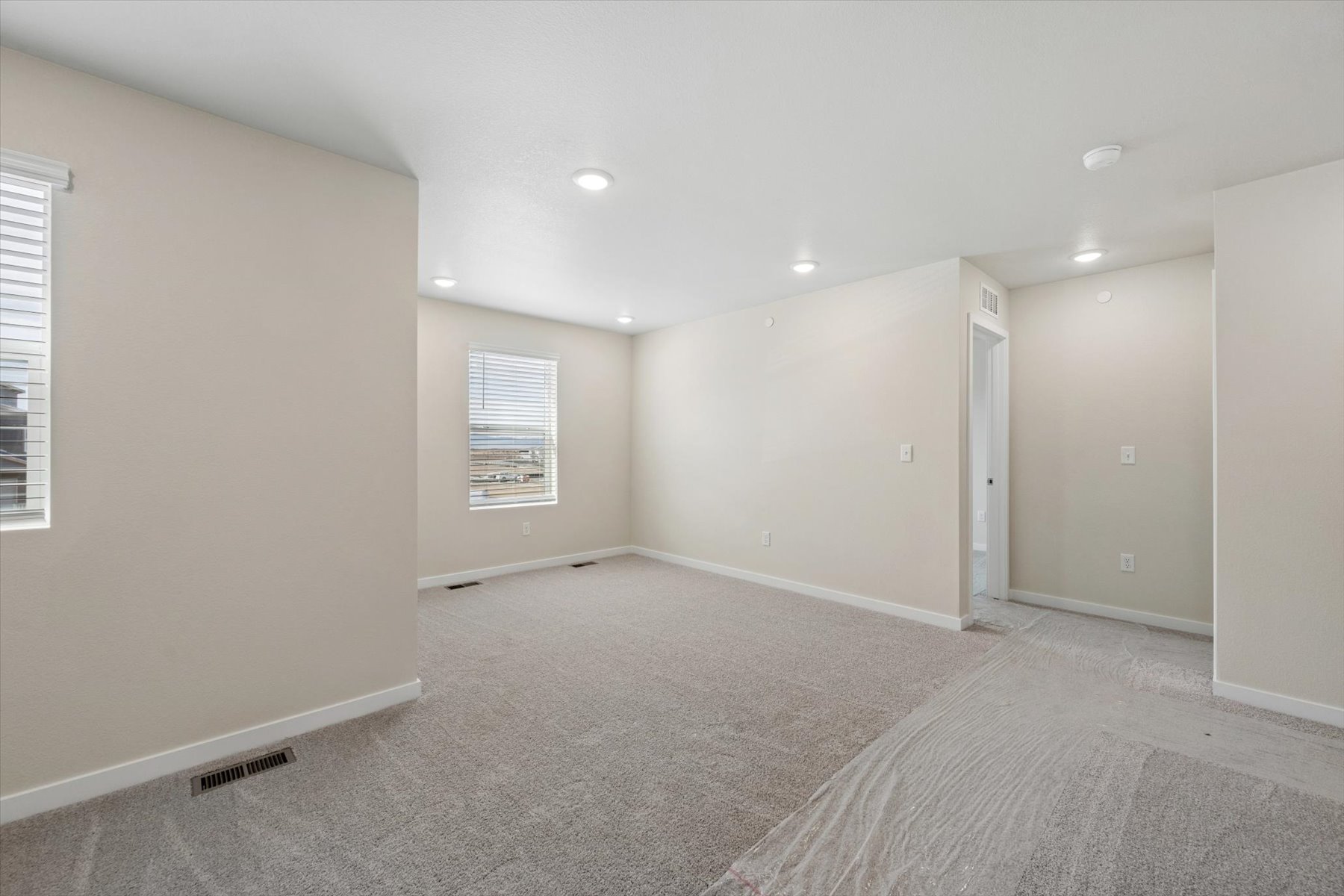 A room with a carpet and a rug.