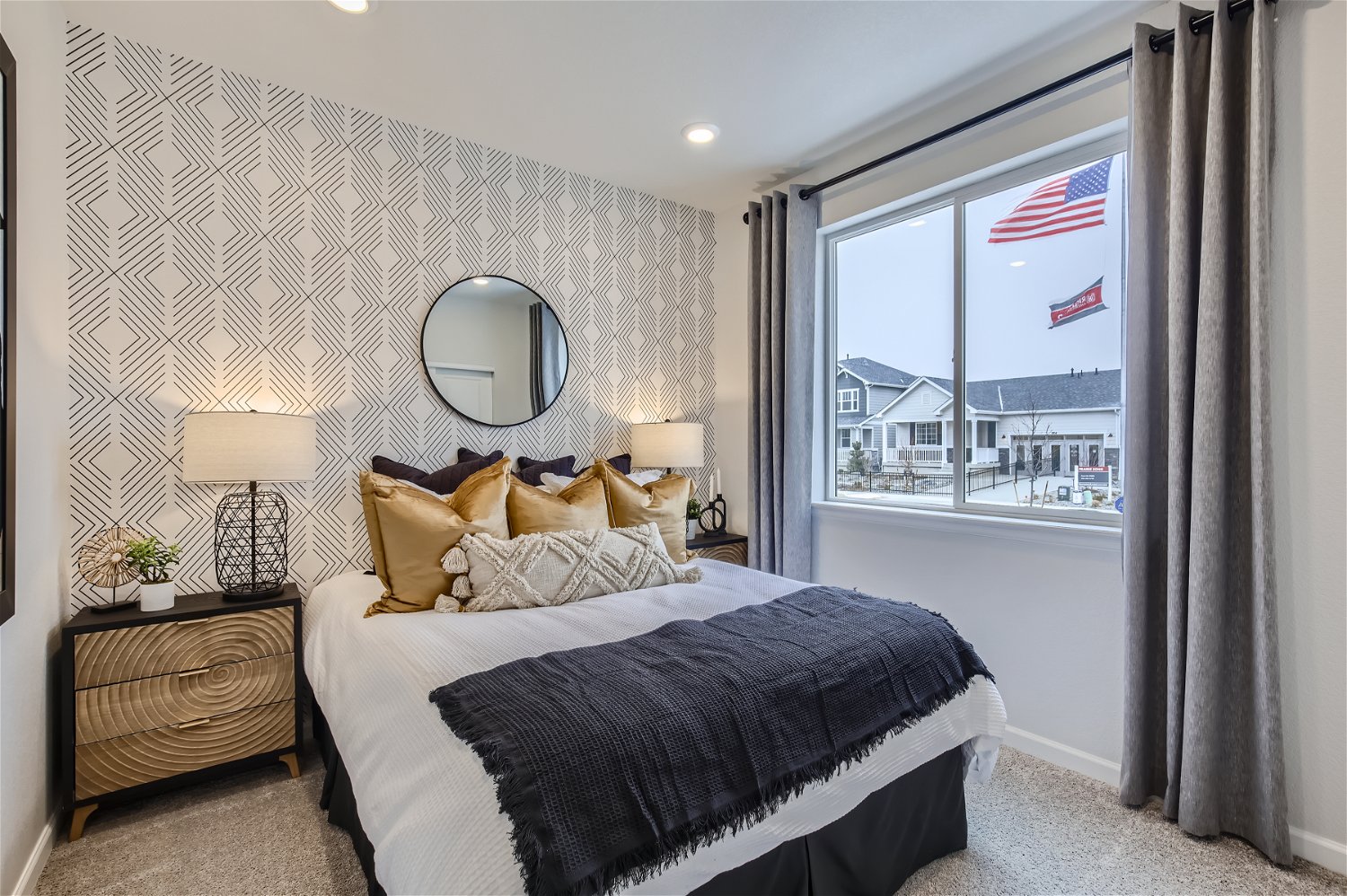 A bedroom with a large window.