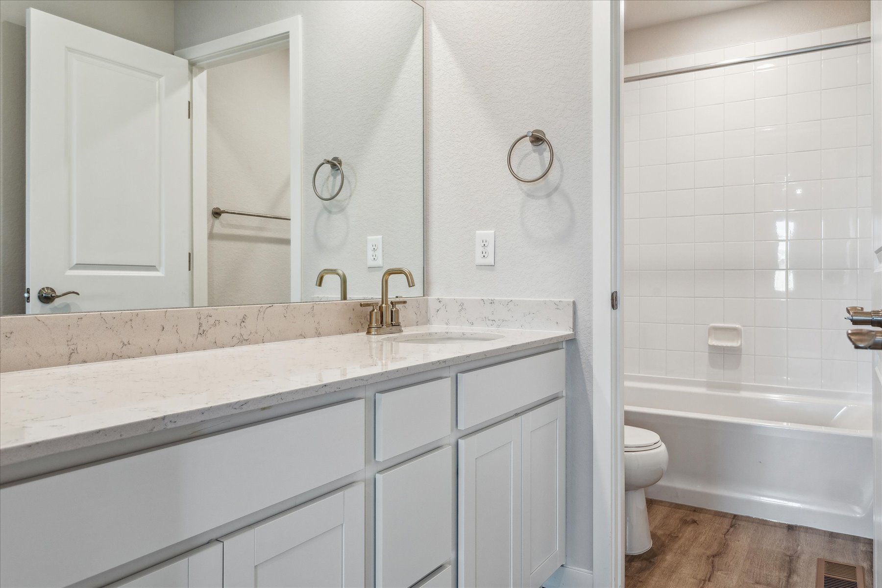 A bathroom with a tub sink and toilet.