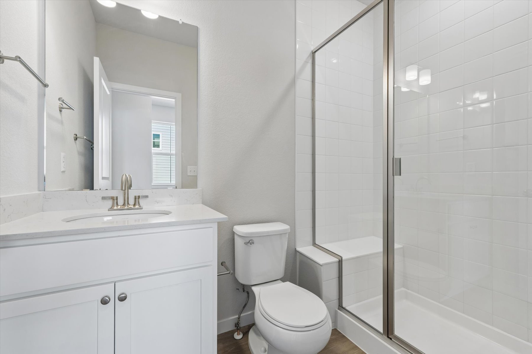 A bathroom with a shower and toilet.