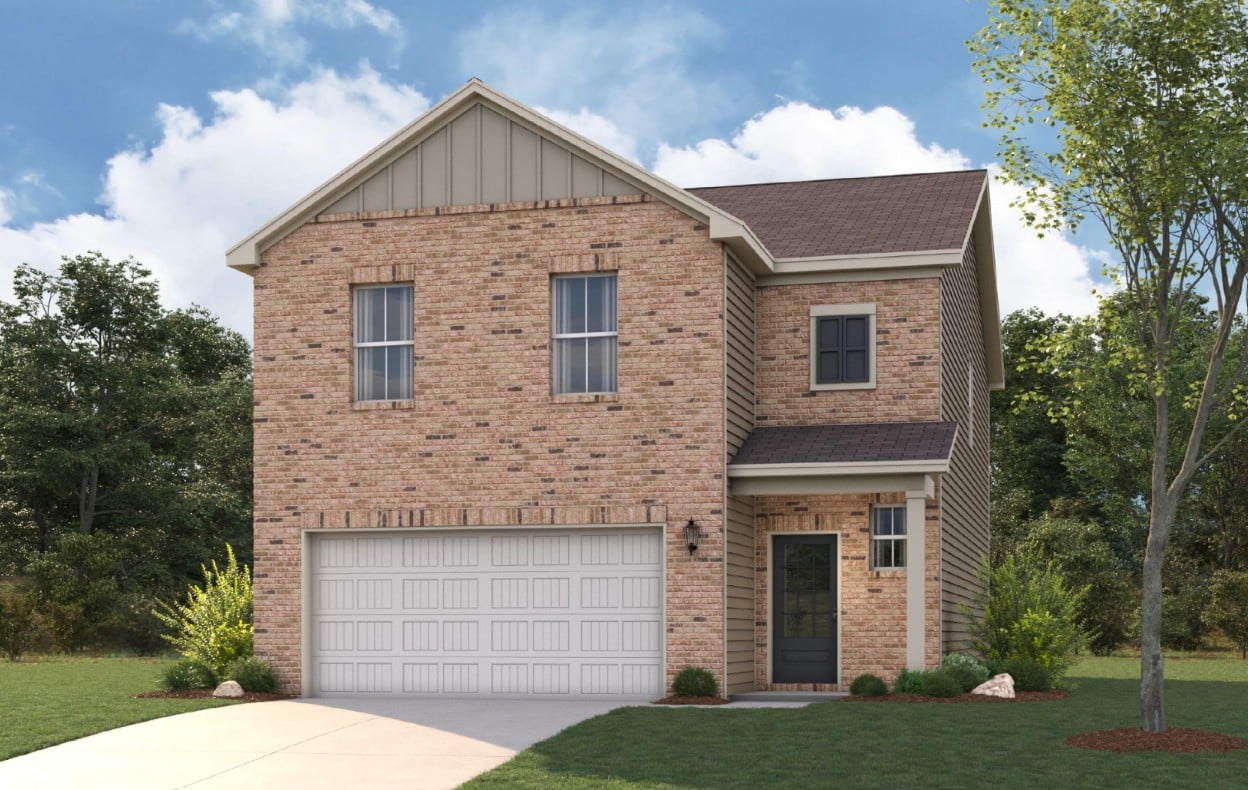 A brick house with a garage.