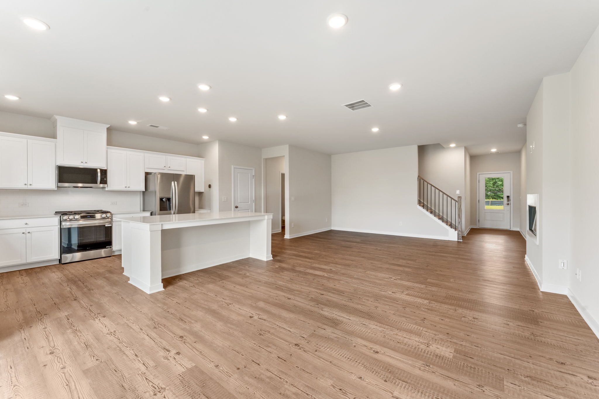 A large kitchen with white cabinets.