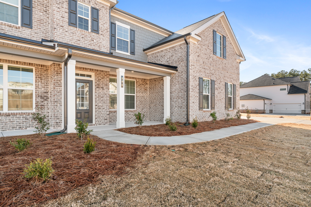 A brick building with a driveway.
