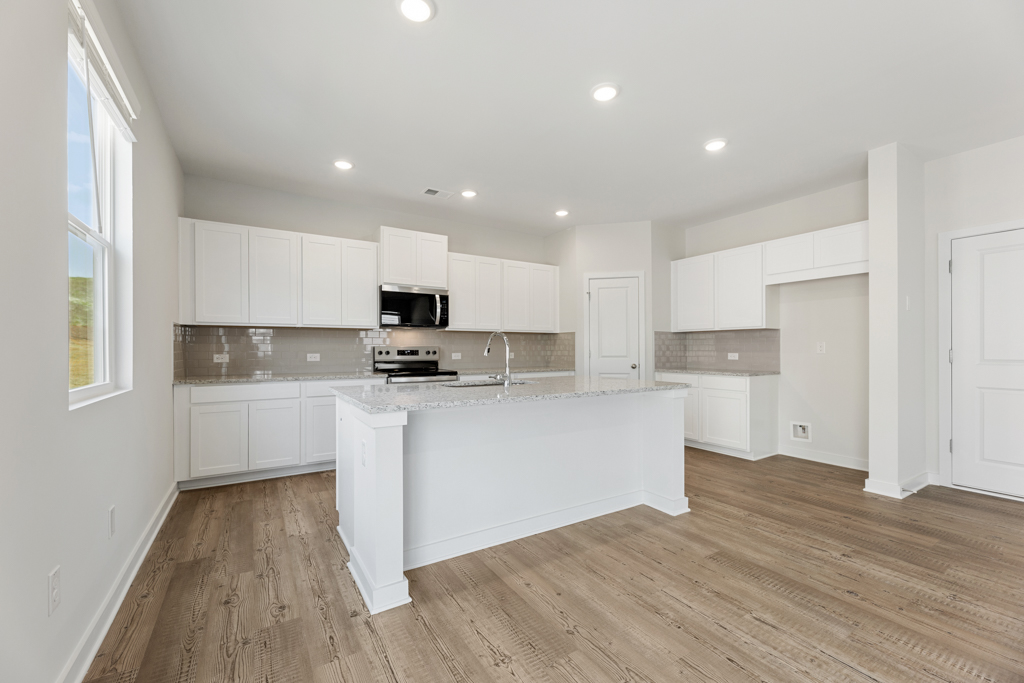 A kitchen with white cabinets.