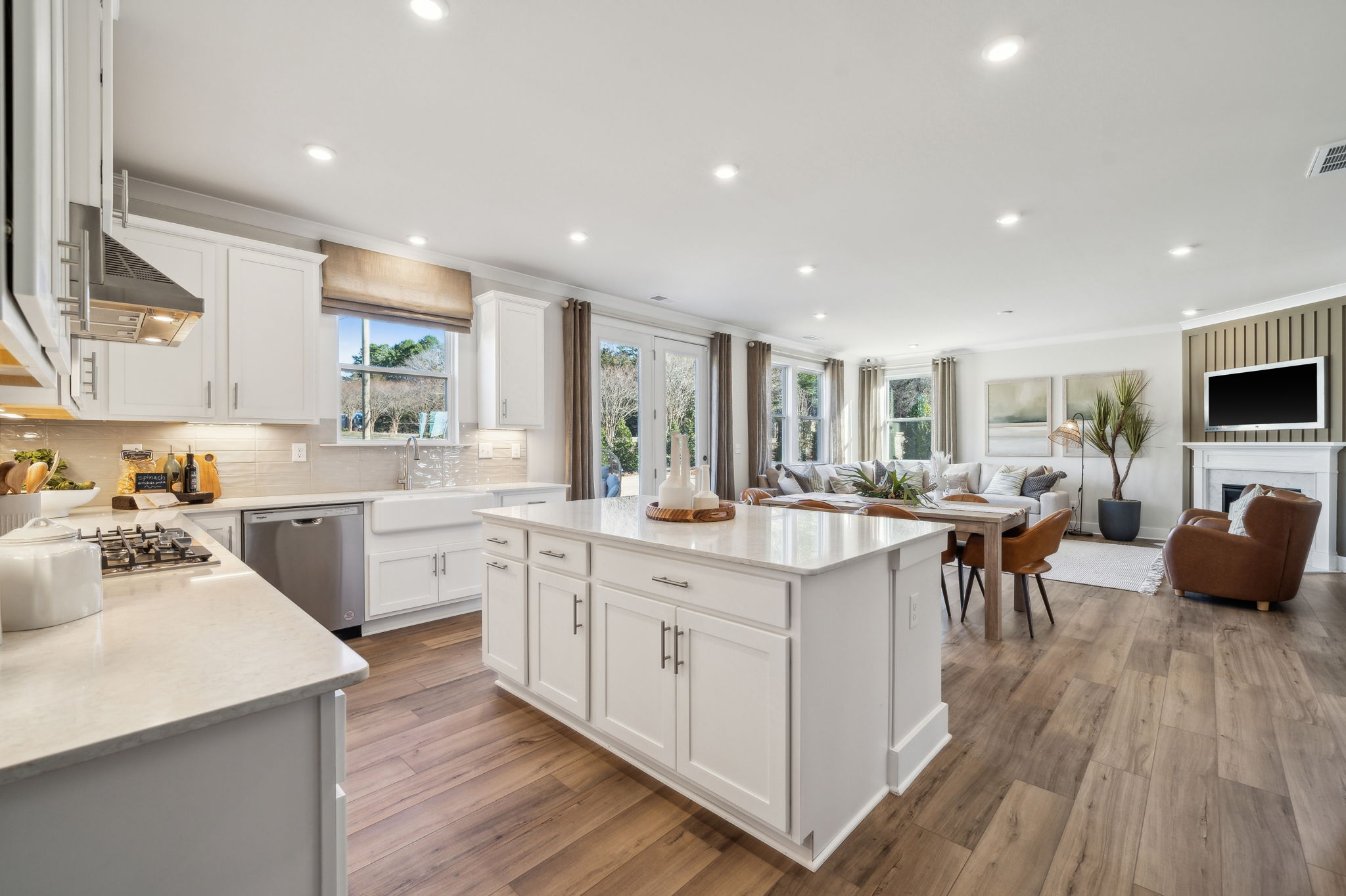 A kitchen with white cabinets.