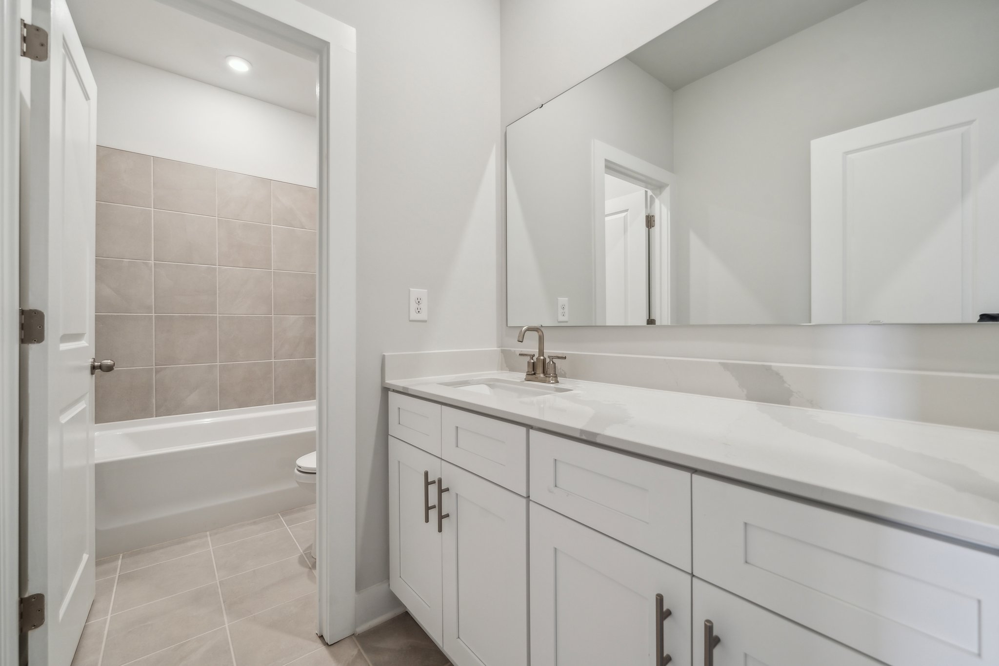 A bathroom with a tub sink and toilet.