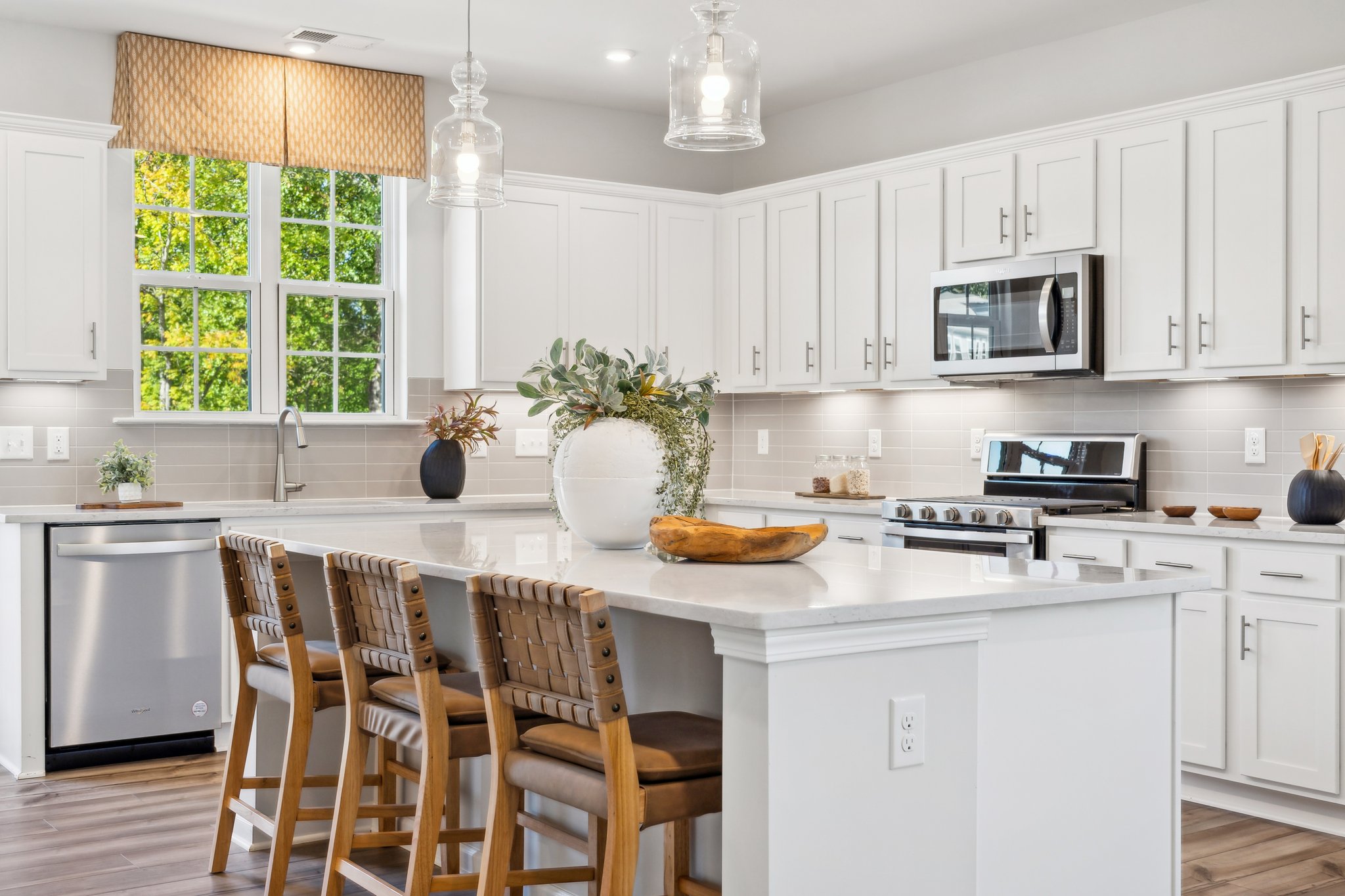 A kitchen with white cabinets.