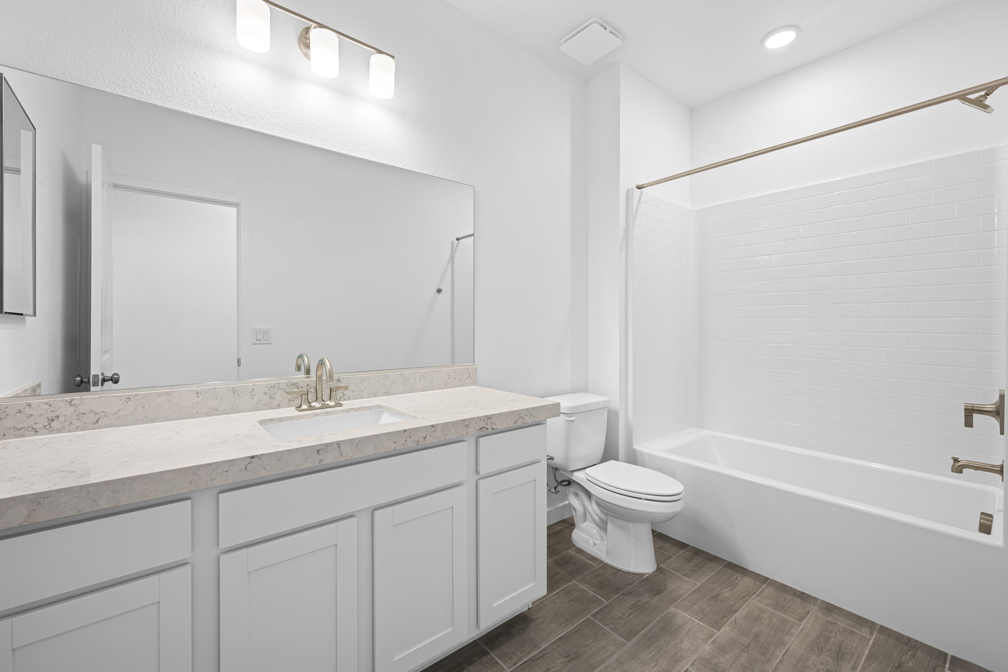 A bathroom with a tub sink and toilet.