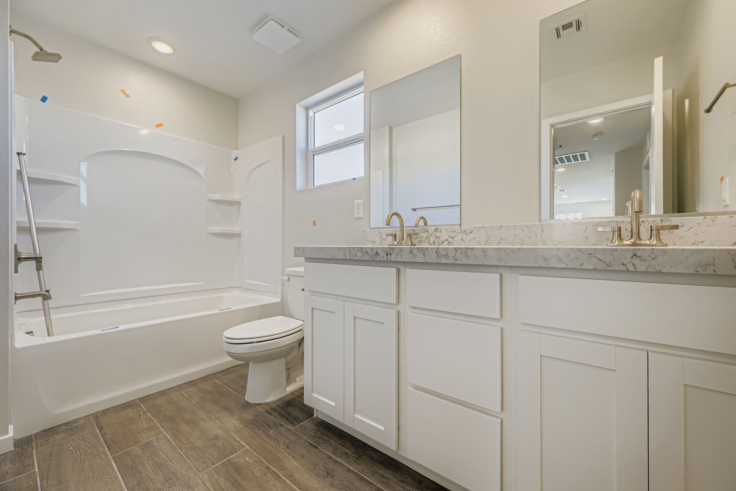 A bathroom with a tub toilet and sink.