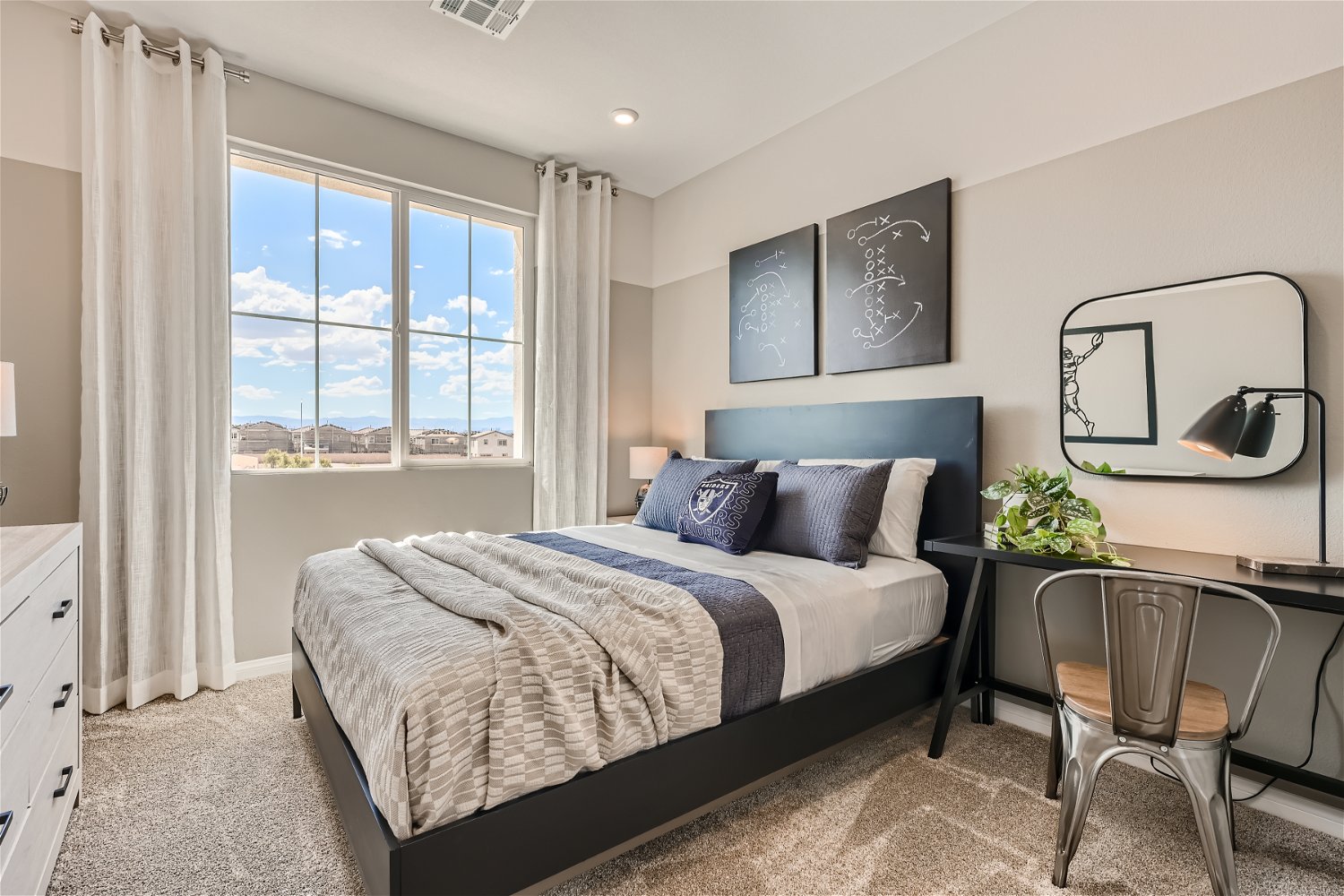 A bedroom with a large window.