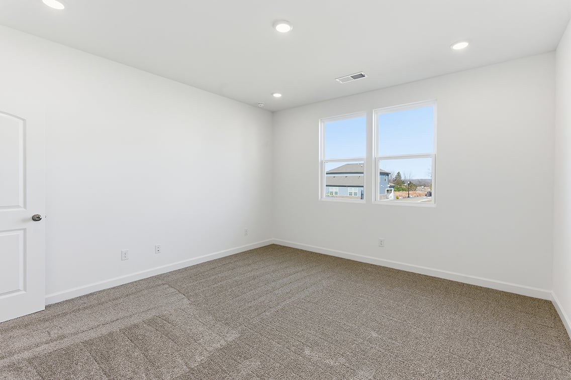 A room with a window and a carpet.